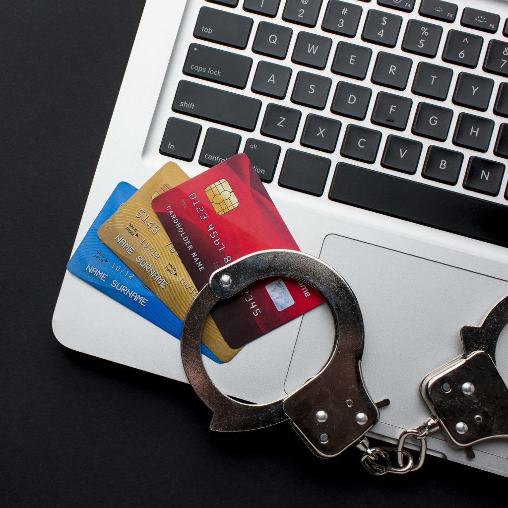 laptop, cartões de crédito e algemas
